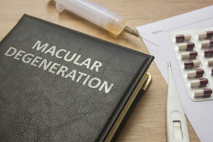 Book about Macular degeneration and medication, injection, syringe and pills stock photo